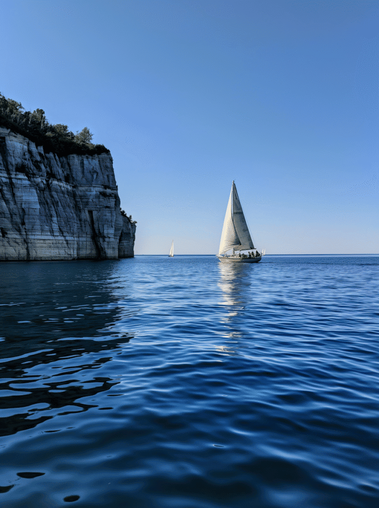 Peaceful ocean view with sailboats, reflecting guidance and ease in managing small business finances.